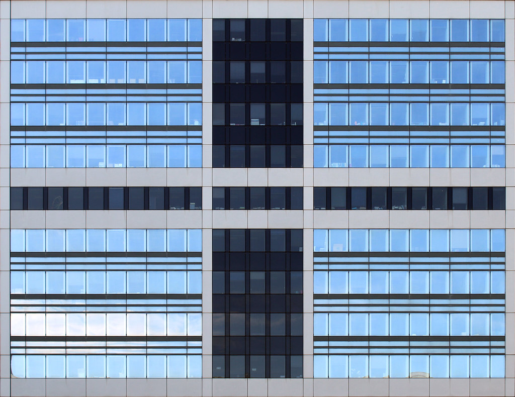Symmetrische blaue Bürofassade mit vielen Fenstern