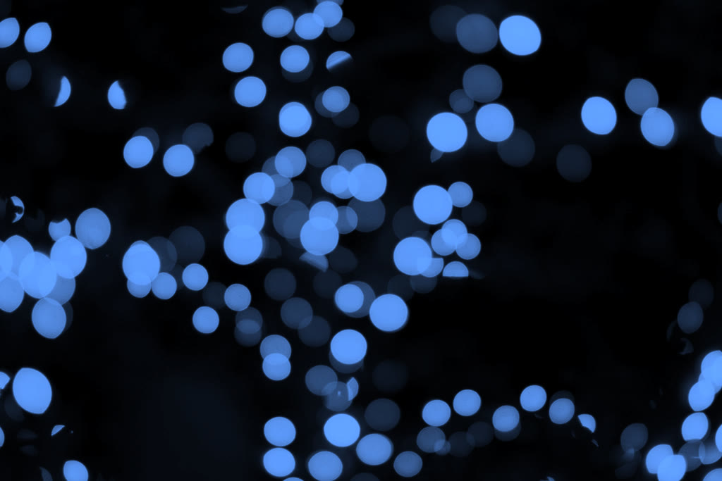 Viele blaue Lichtkreise auf dunklem Grund